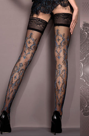 A person wears black thigh-high Ballerina 416 Hold Ups Nero featuring intricate blue floral lace patterns, paired with black high heels. Their hands rest on their upper thighs, and they stand against a neutral-toned background with an ornate silver decorative design on the right side, from the Ballerina Hush Hush collection.