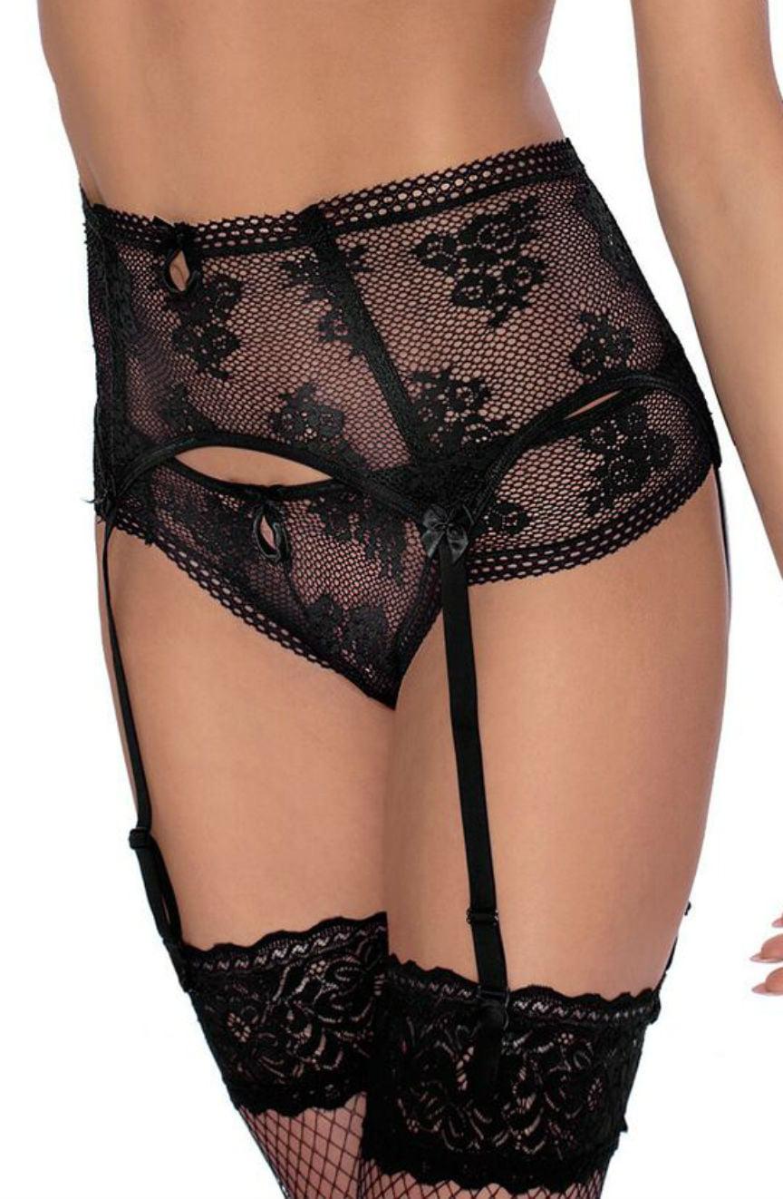 A model showcasing the Roza Euterpe Black Suspender Belt lingerie set, which includes a high-waisted garter belt adorned with floral detailing and matching thigh-high stockings, paired with a deep cut bra. The ensemble features black straps and ornamental bows, focusing on the torso and upper legs against a plain background.