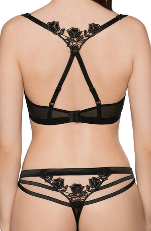 A woman is wearing a matching black lingerie set. The back view showcases a strappy bra with intricate floral lace detailing at the center, reminiscent of a Roza box design, and the Roza Lisbet Black Thong featuring similar floral lace patterns and multiple thin straps.