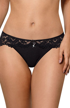 Close-up of a woman wearing the Roza Newia Black Soft Cup Bra. This elegant lingerie piece from the Roza brand features an intricate lace design with scalloped edges and a small decorative bow at the center front. The background is plain white, focusing attention on the garment.