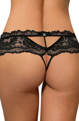 A person's lower back and buttocks are shown wearing the Roza Sefia Thong Black. This design, part of the Roza Collection, features intricate lace patterns and thin straps, creating a bold and elegant look.