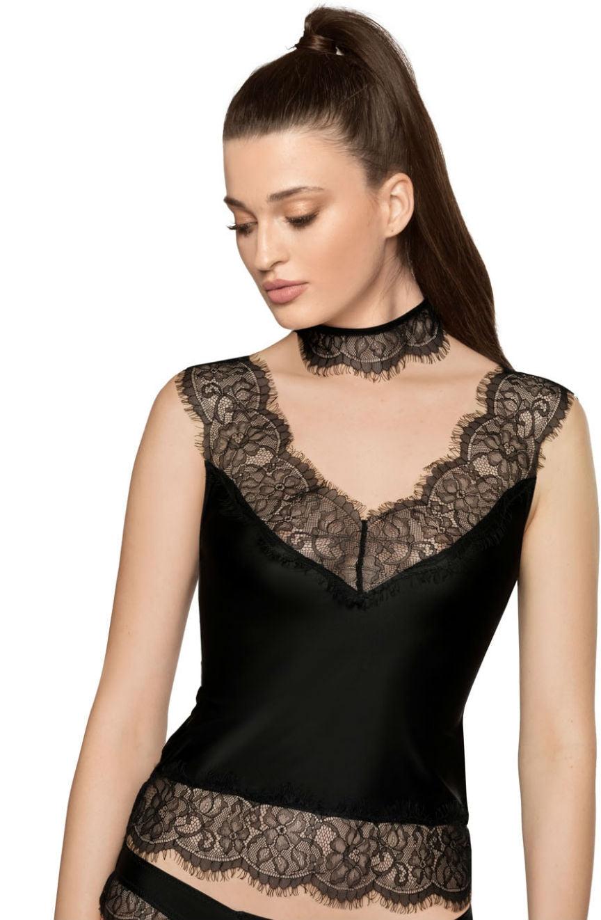 A woman with long brown hair in a high ponytail is wearing the Roza Sija Black Shirt by Roza, featuring luxurious eyelash lace trim around the neckline, waist, and shoulders. The outfit includes a matching lace choker. She looks downward with a serene expression on her face.