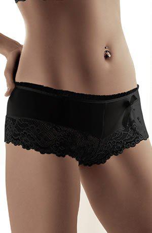 A woman adorned in the stylish Roza Sisi Black Shorts, featuring a black lace design with a bow, stands against a white backdrop. Paired with the elegant Roza Sisi bra, the photo highlights her midsection and hips, emphasizing the fashionable and delicate design of this everyday wear lingerie. She also sports a belly button piercing.