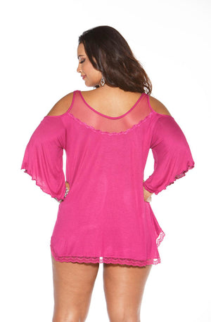 A woman is standing with her back to the camera, wearing the Shirley Of Hollywood X3257 Sleepshirt in magenta by Shirley of Hollywood. The bright pink, cold-shoulder tunic features elegant lace trim along the sleeves and hem. The deep "V" neckline beautifully complements her medium-length dark hair and drop earrings.