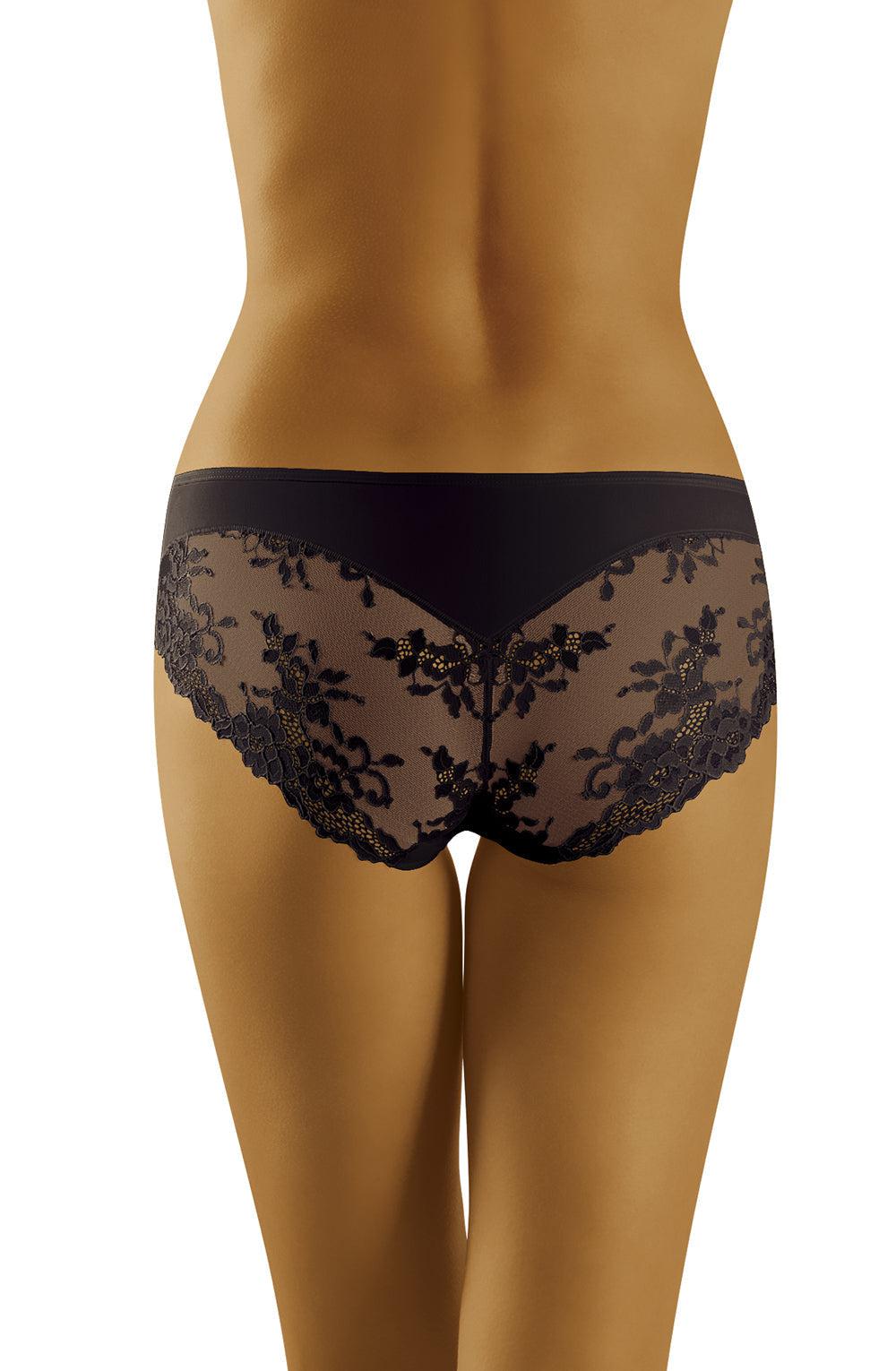 A person is shown from the back, wearing the Wolbar Aria Black Brief from Wolbar. The underwear features a stunning floral lace design that extends from the waistband to the mid-hip area, exuding a blend of sophisticated comfort and elegance. The background remains plain and unobtrusive.