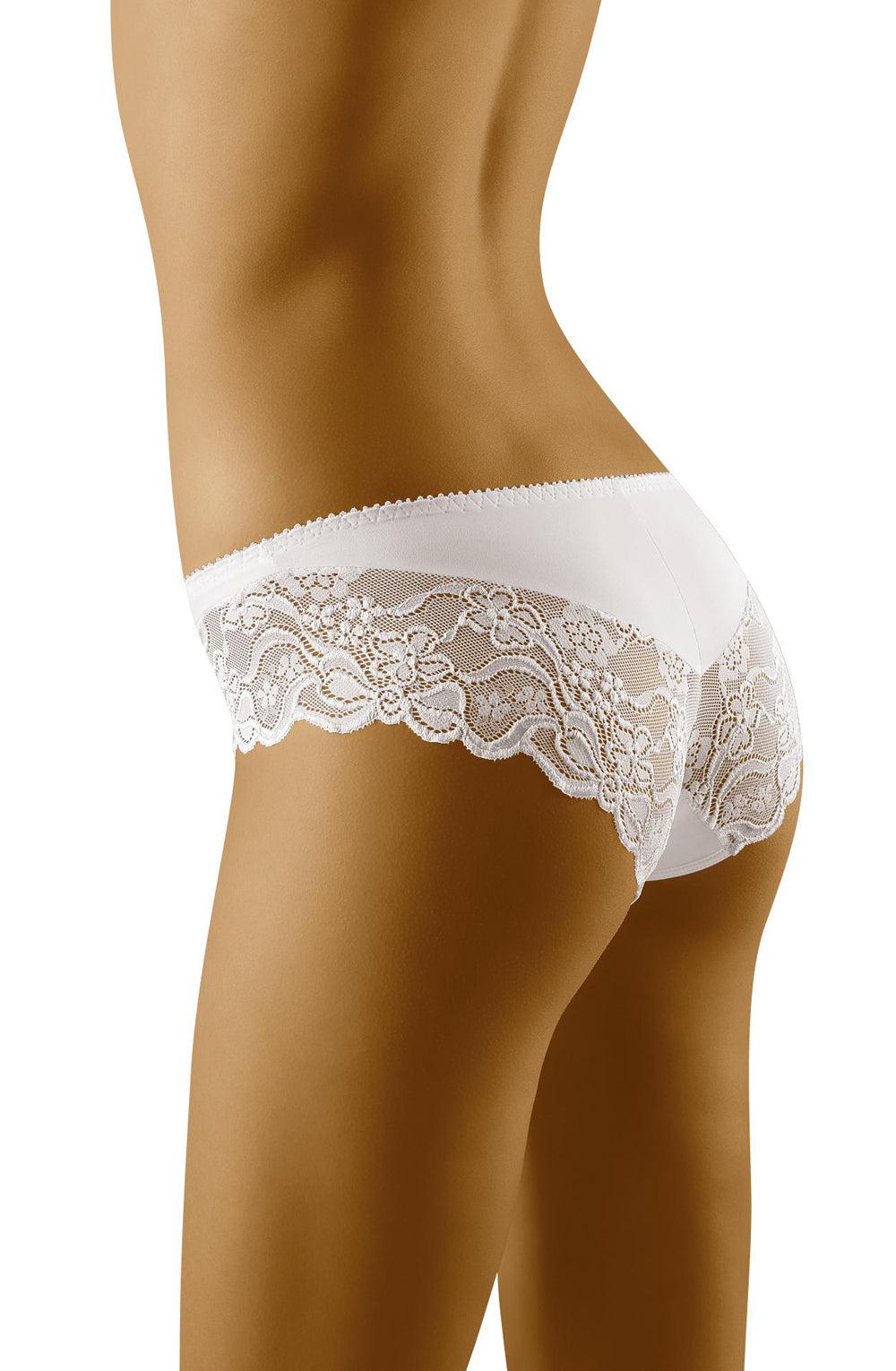 A person is wearing the Wolbar Emma White Brief by Wolbar, showcasing delicate lace designs. The panties feature sheer floral lace detailing on the sides and back. The image focuses on the midsection, emphasizing the sophisticated charm of the lingerie.